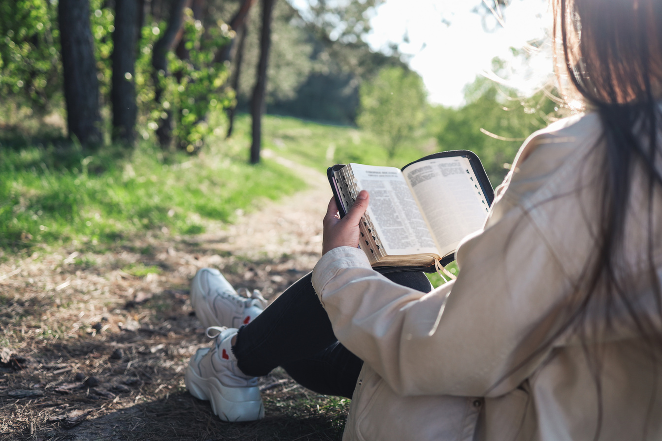 Christian woman holds bible in her hands. Reading the Bible